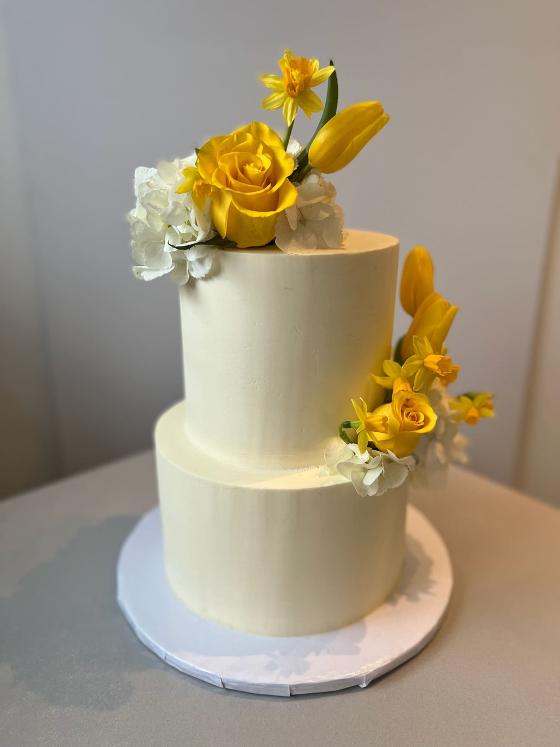 Fresh blooms on buttercream - wedding cake