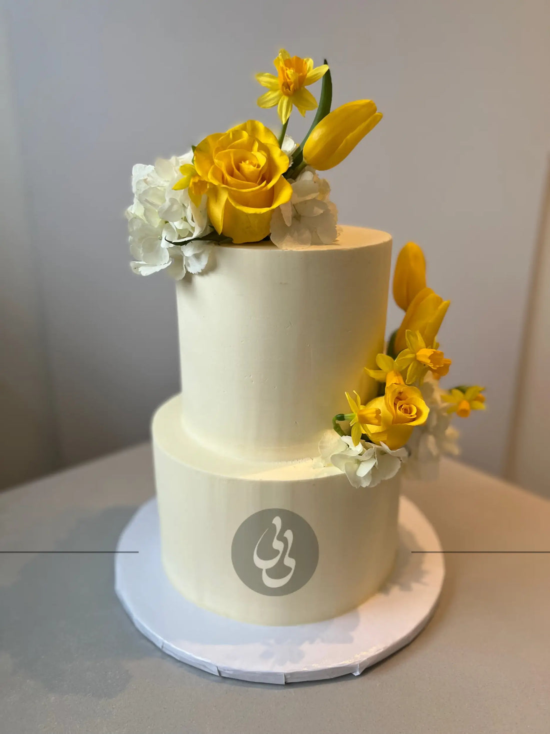 Fresh blooms on buttercream - wedding cake