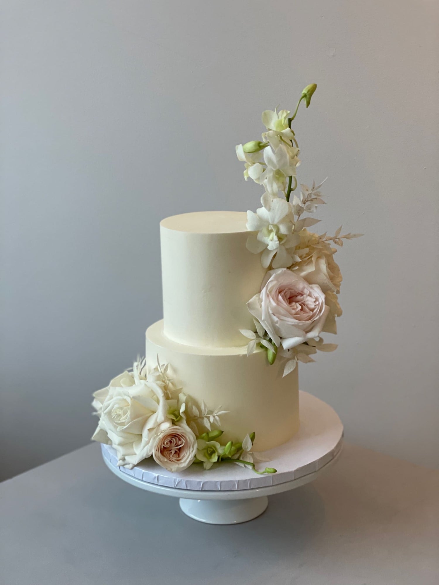 Fresh blooms on buttercream - wedding cake