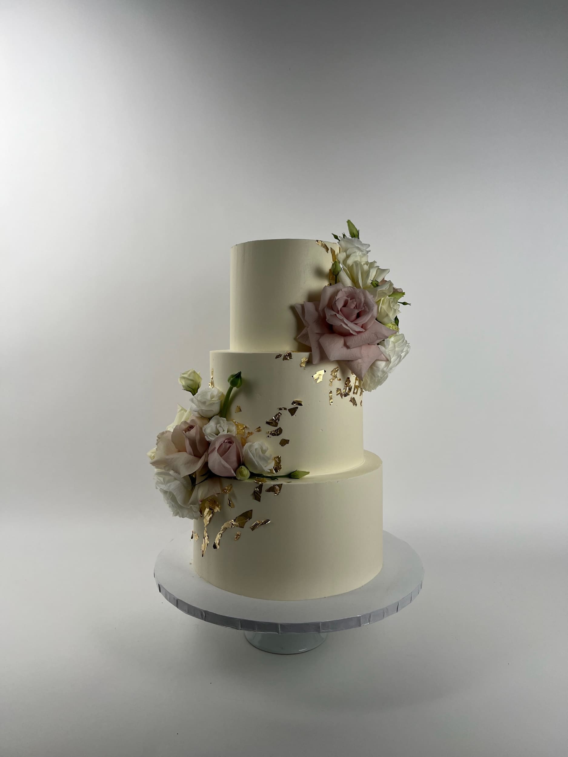 Fresh flowers on gilded buttercream - wedding cake