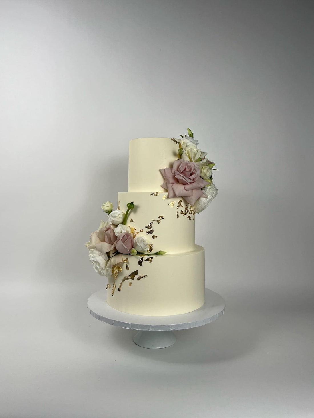 Fresh flowers on gilded buttercream - wedding cake