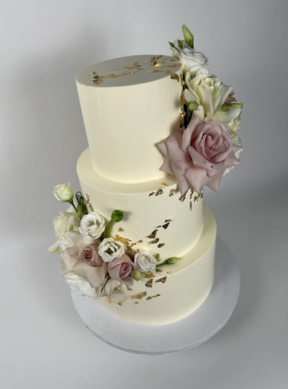 Fresh flowers on gilded buttercream - wedding cake
