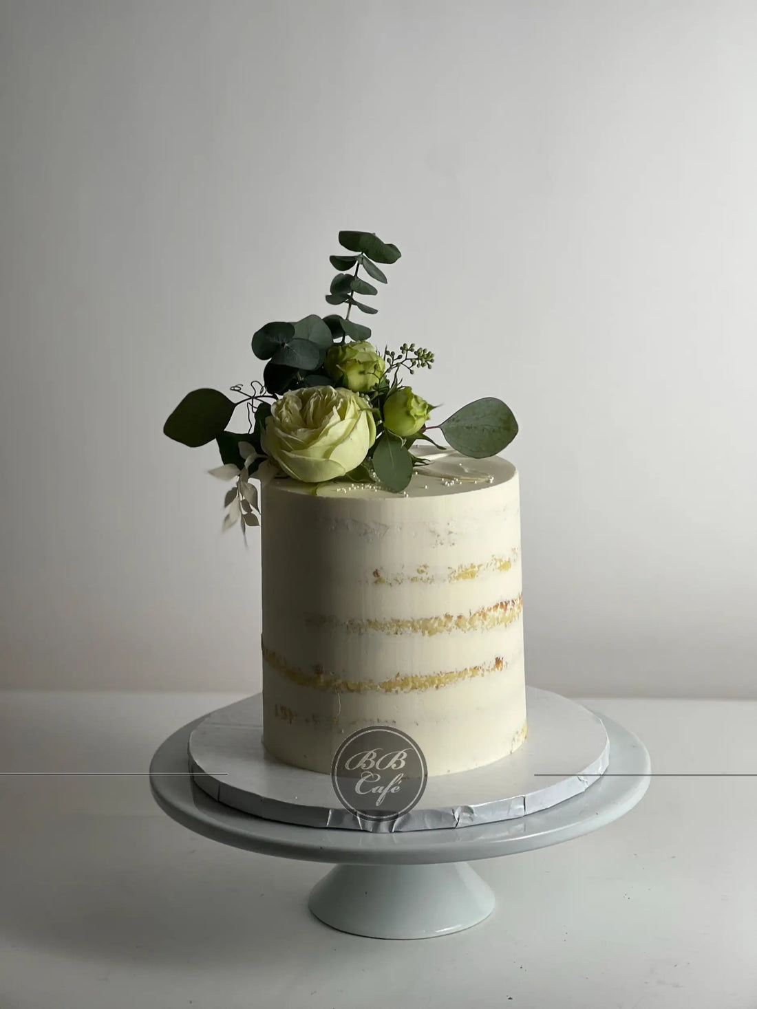 Fresh flowers on semi - naked buttercream - custom cake