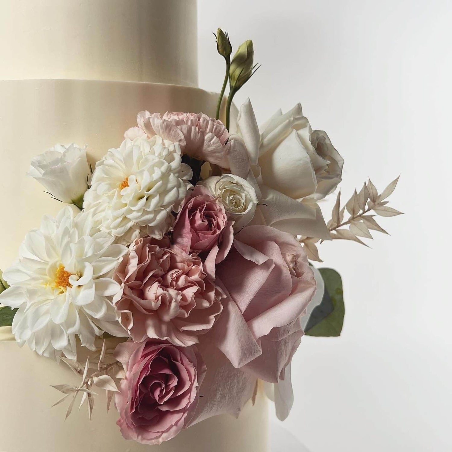 Fresh flowers on smooth buttercream - wedding cake
