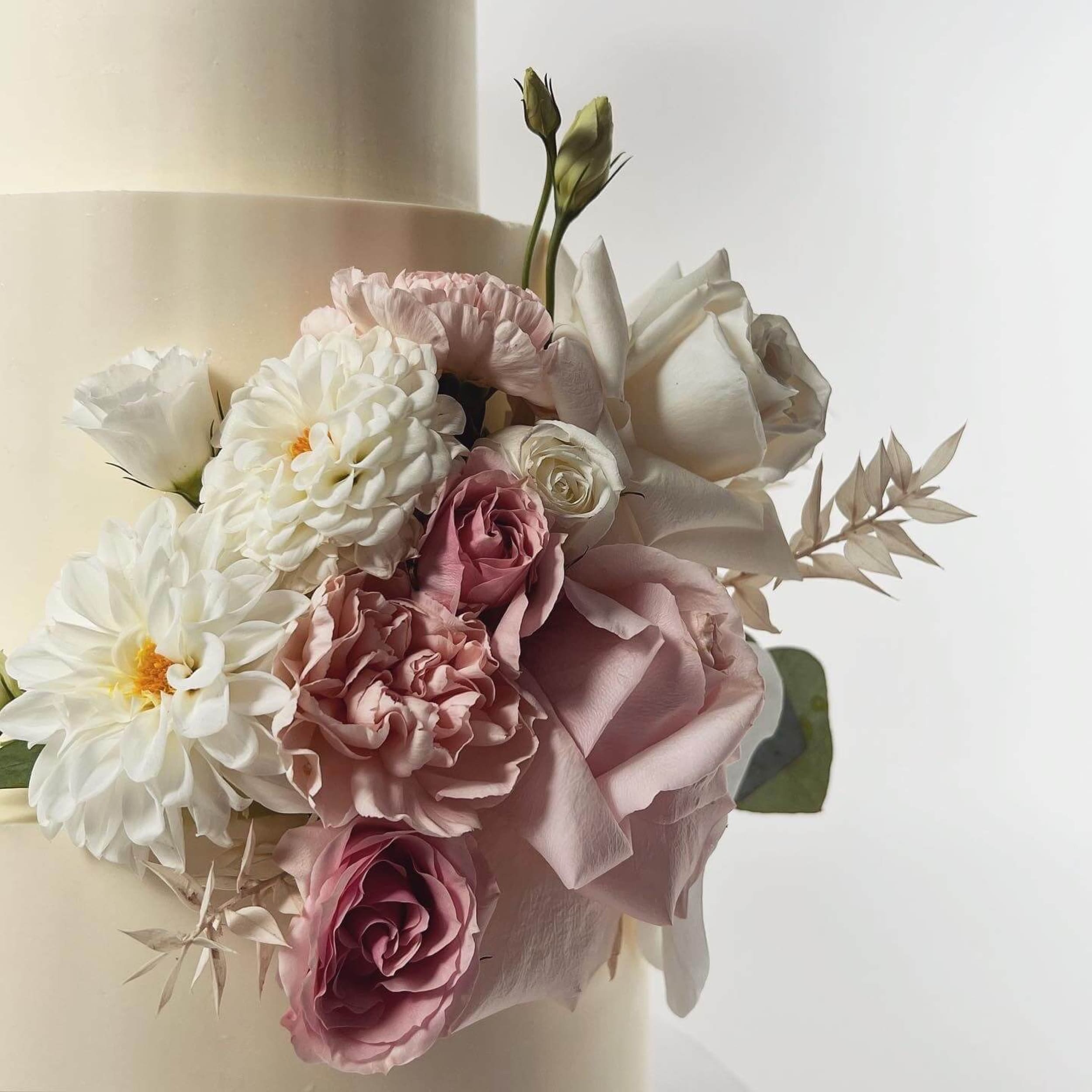 Fresh flowers on smooth buttercream - wedding cake