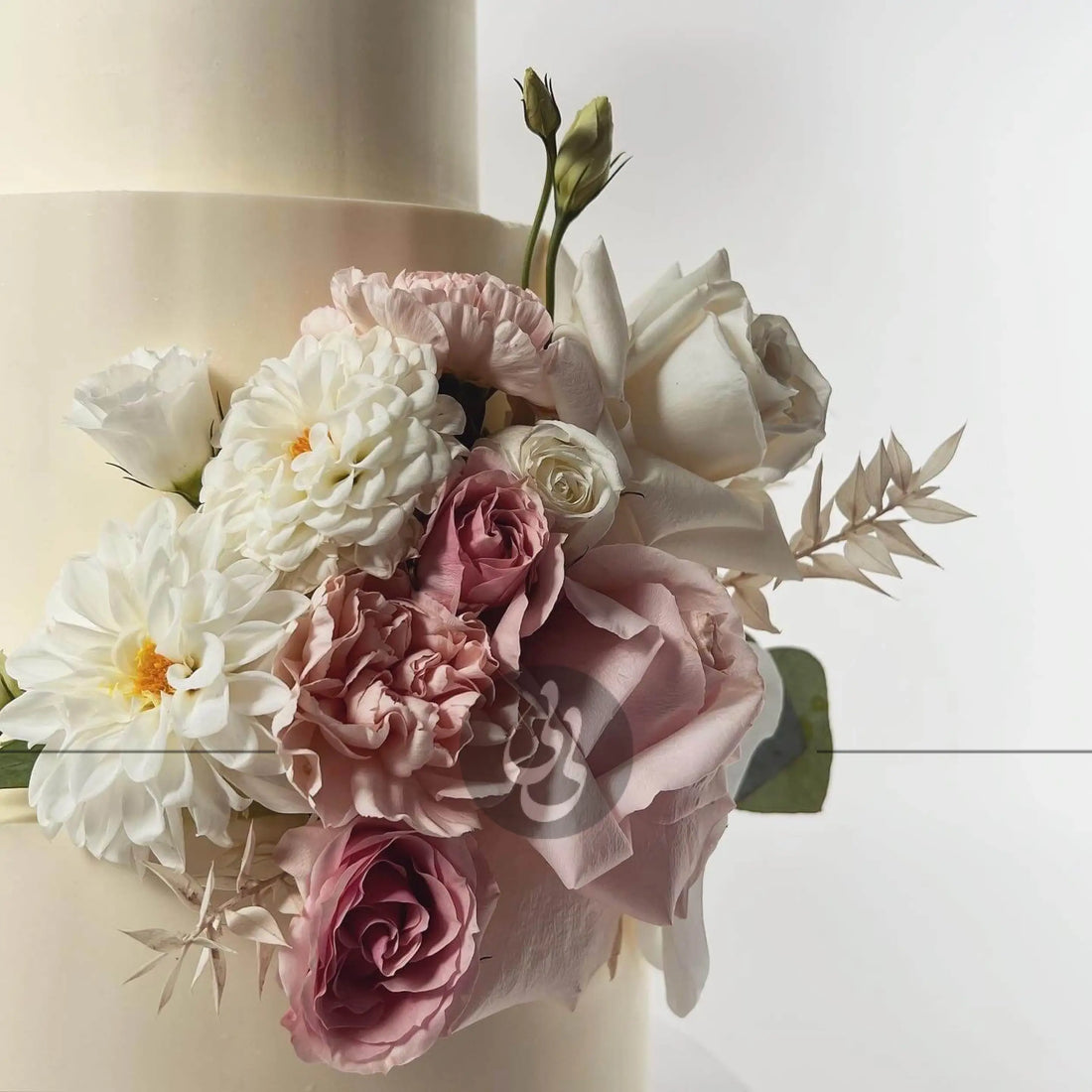 Fresh flowers on smooth buttercream - wedding cake