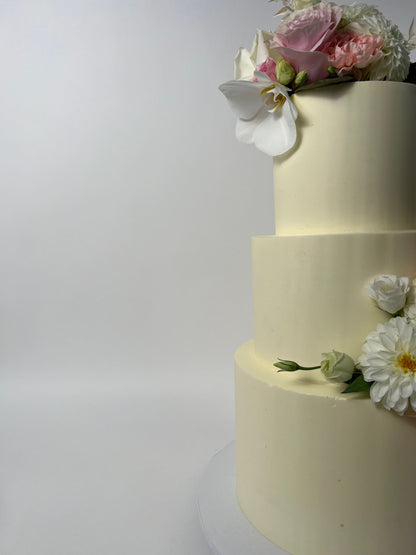 Fresh flowers on smooth buttercream - wedding cake