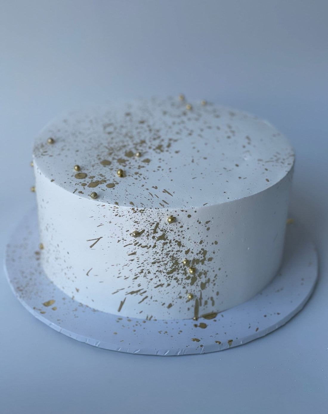 Gold splatter on whipped cream - custom cake