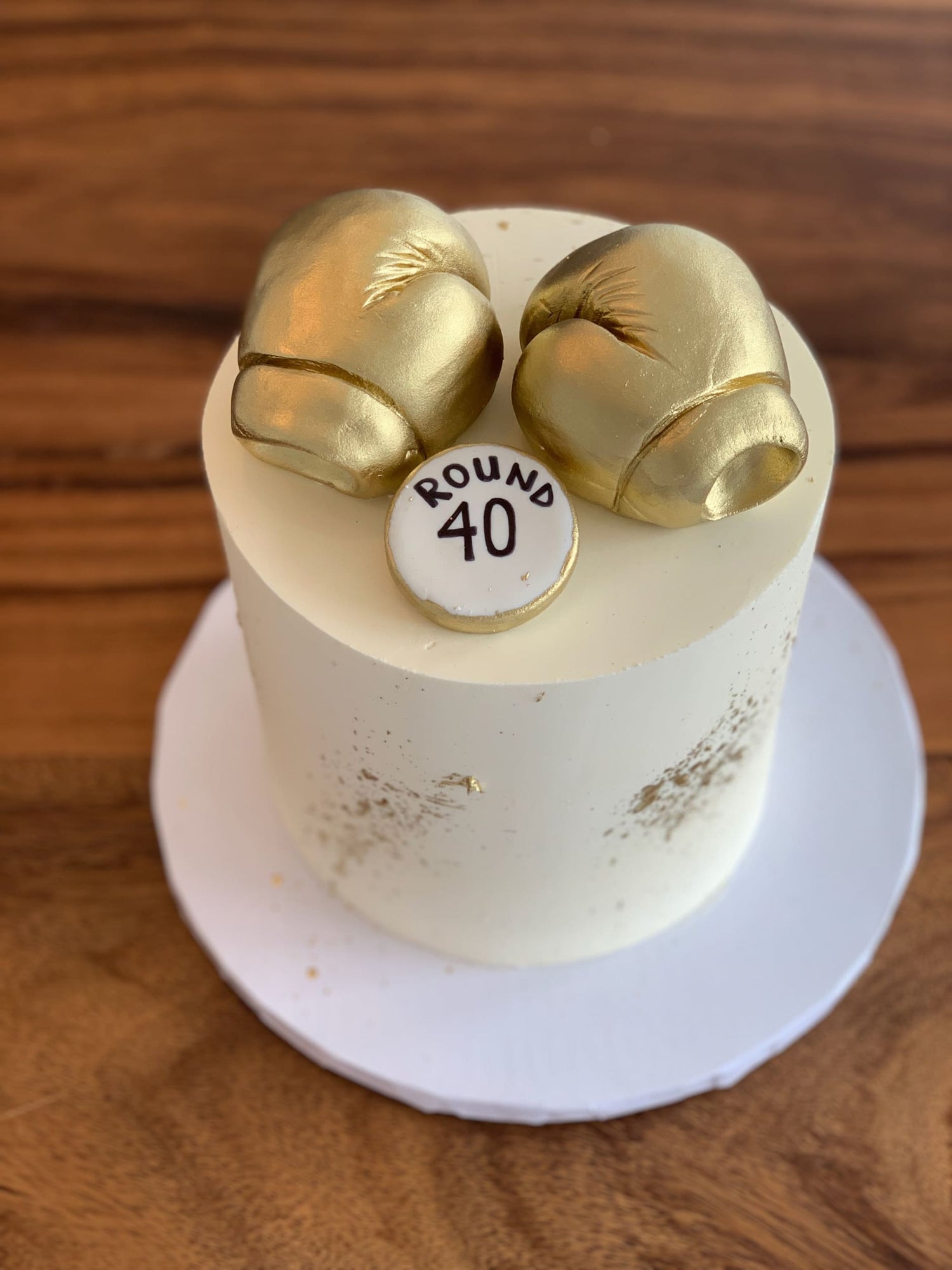 Golden boxing gloves on buttercream - custom cake