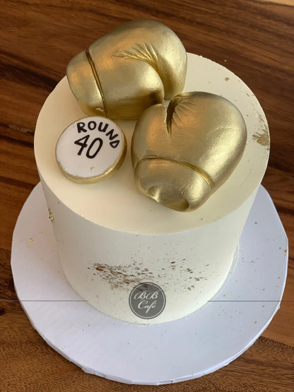 Golden boxing gloves on buttercream - custom cake