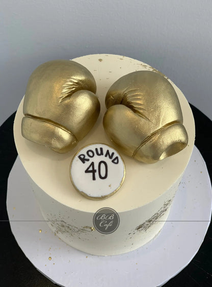 Golden boxing gloves on buttercream - custom cake