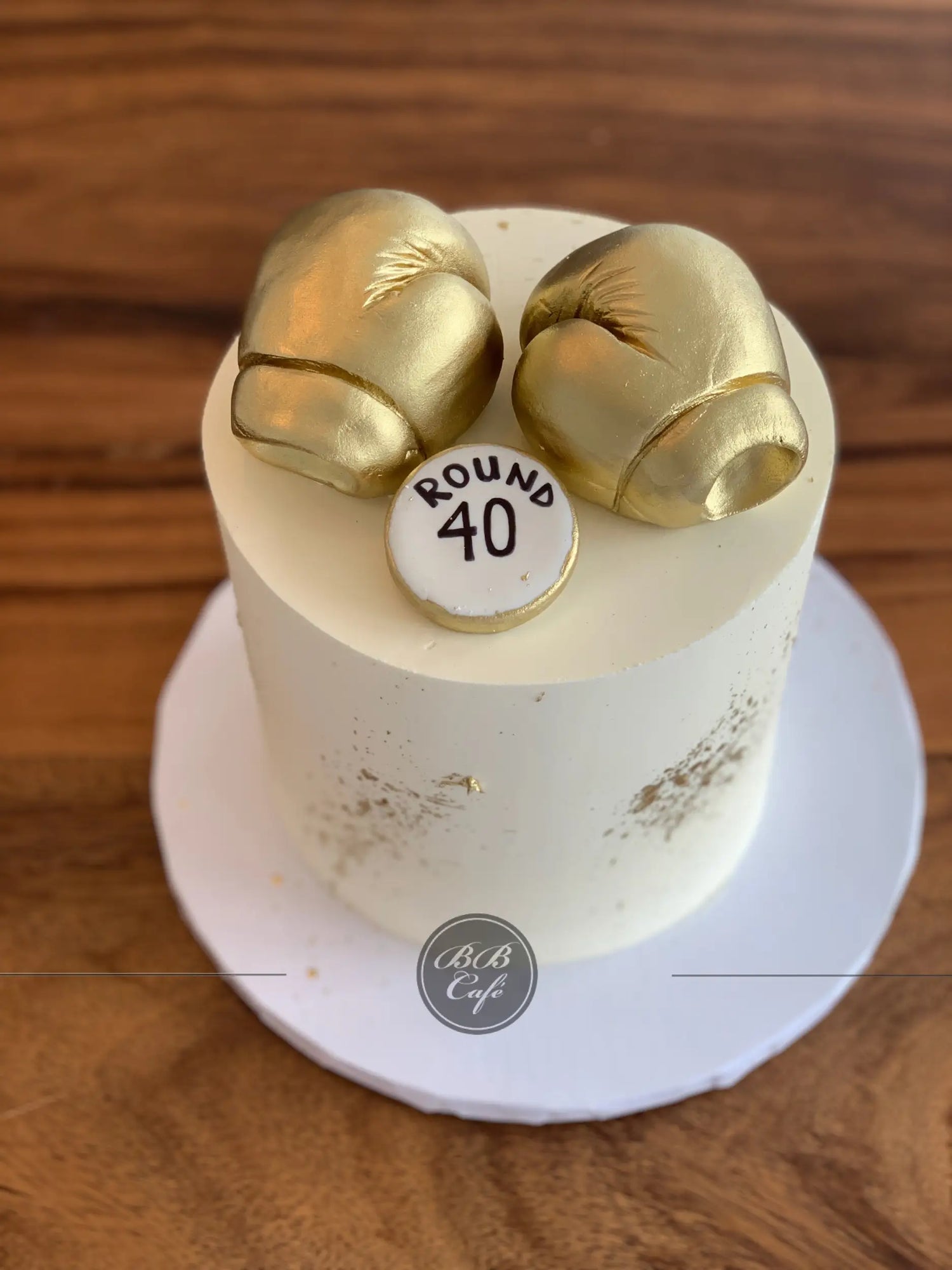 Golden boxing gloves on buttercream - custom cake