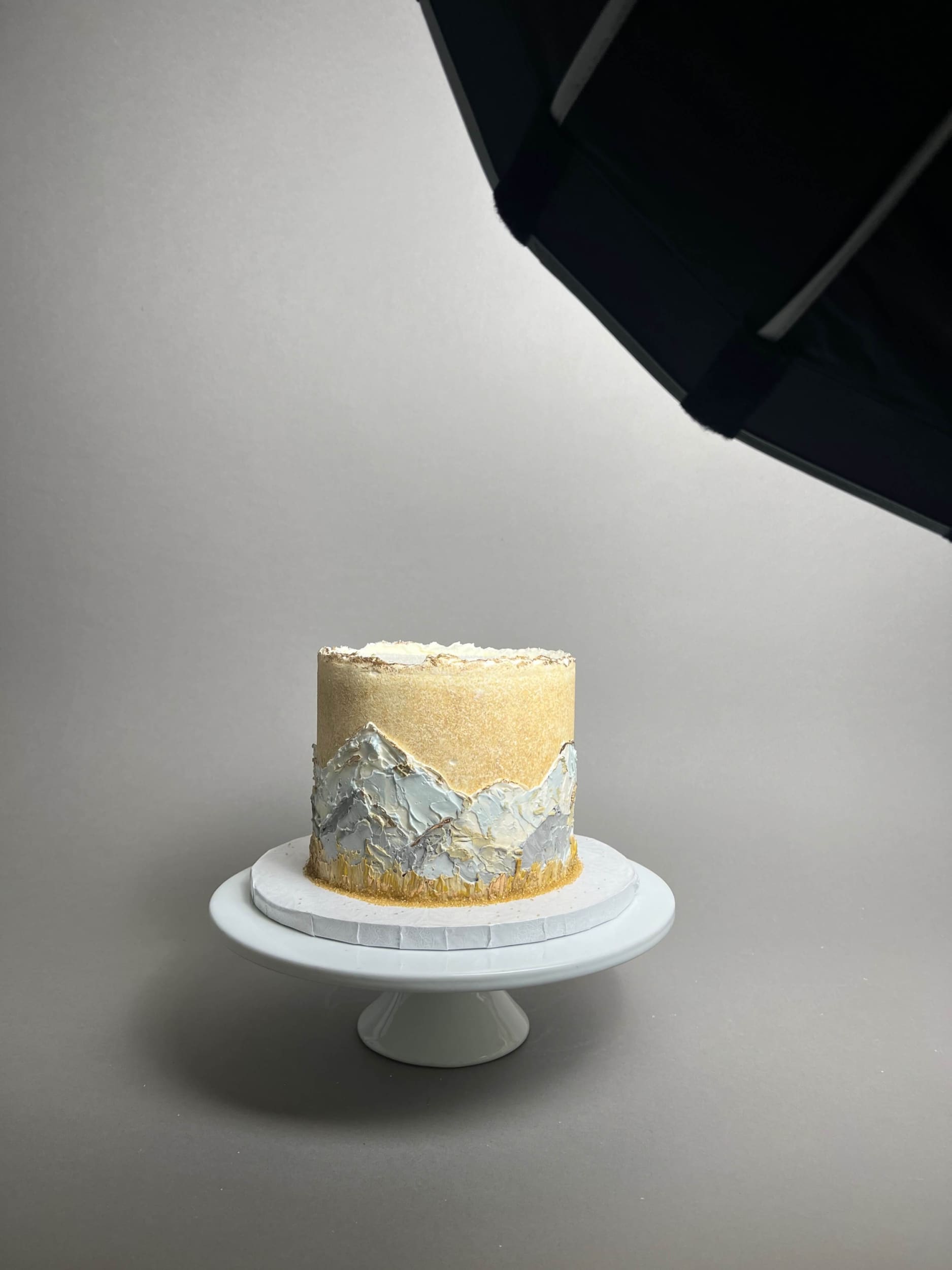 Hand painted mountain scenery on buttercream - custom cake