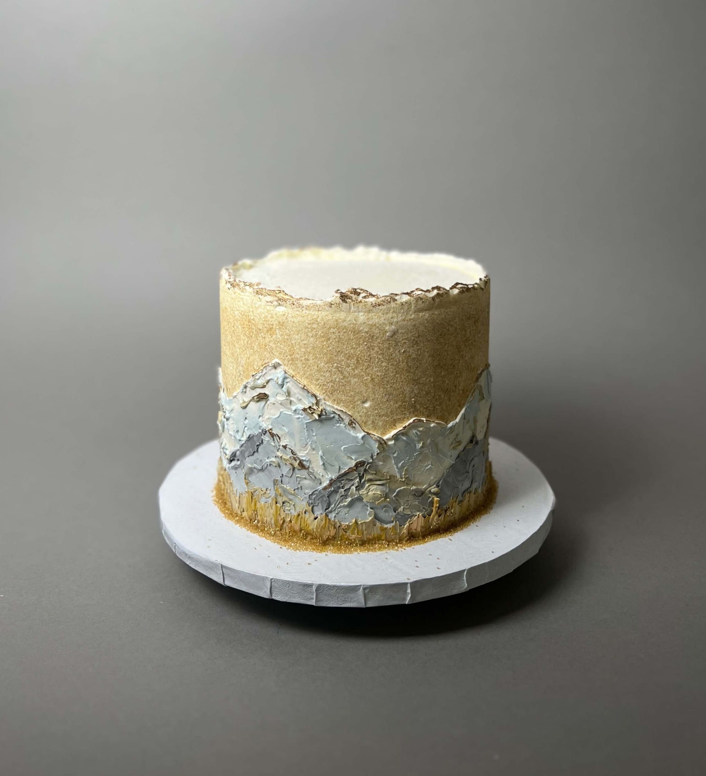 Hand painted mountain scenery on buttercream - custom cake