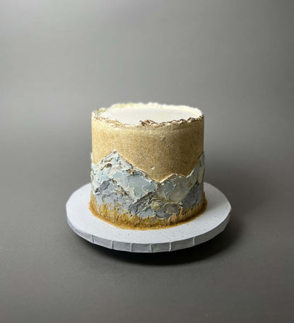 Hand painted mountain scenery on buttercream - custom cake