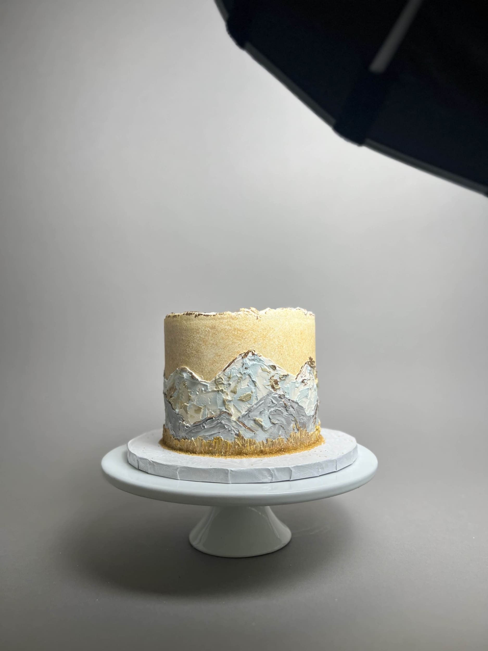Hand painted mountain scenery on buttercream - custom cake