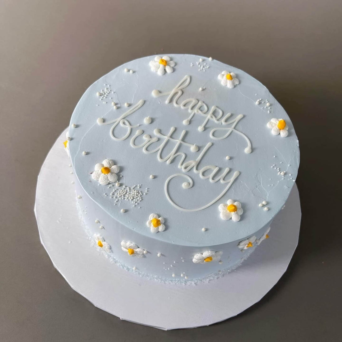 Hand piped daisies on whipped cream - custom cake