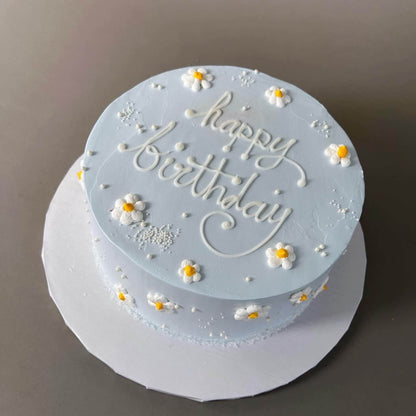 Hand piped daisies on whipped cream - custom cake