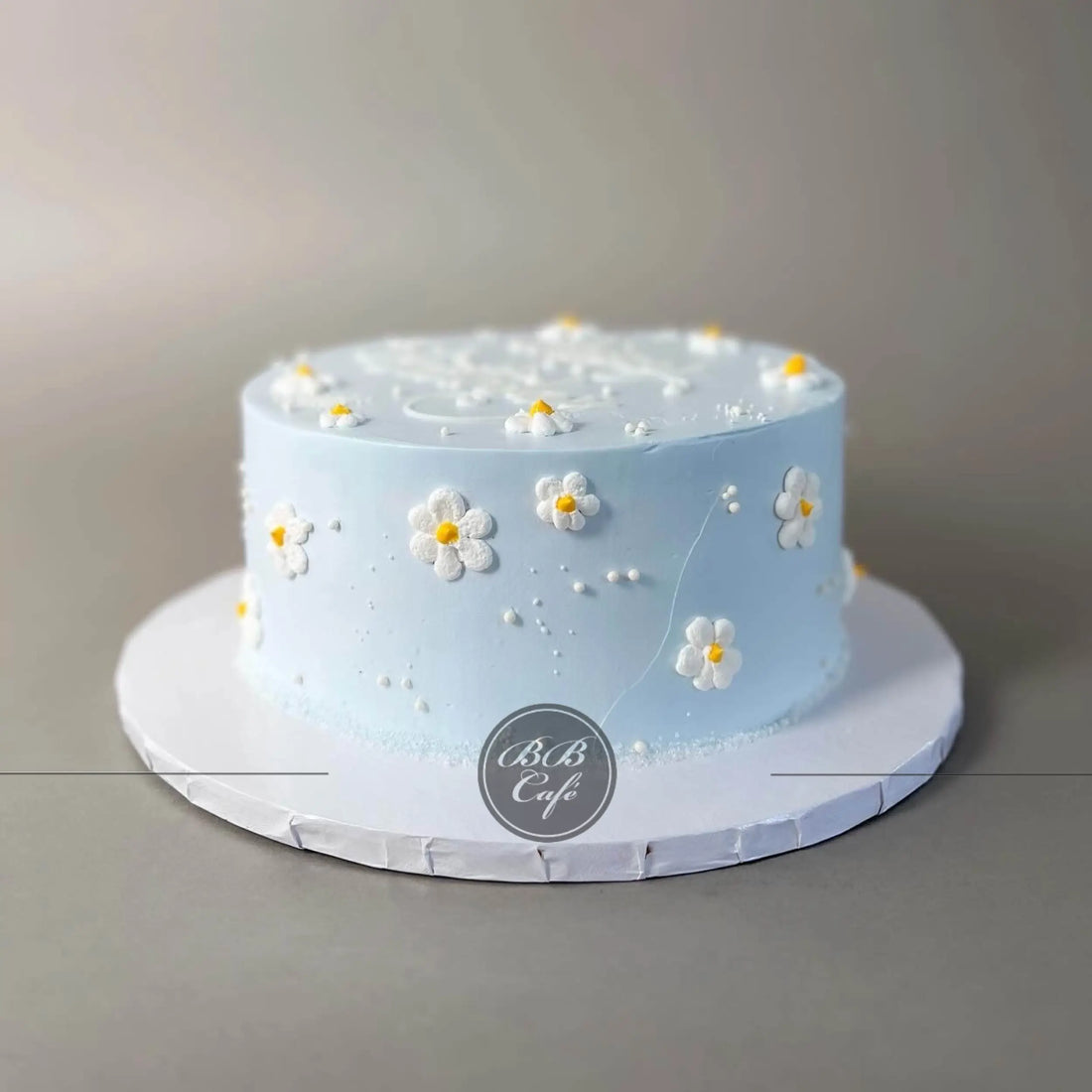 Hand piped daisies on whipped cream - custom cake