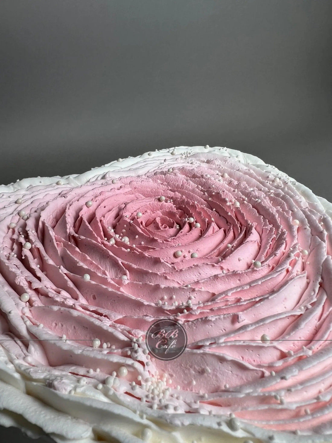 Hand piped ruffled rose on whipped cream heart - custom cake