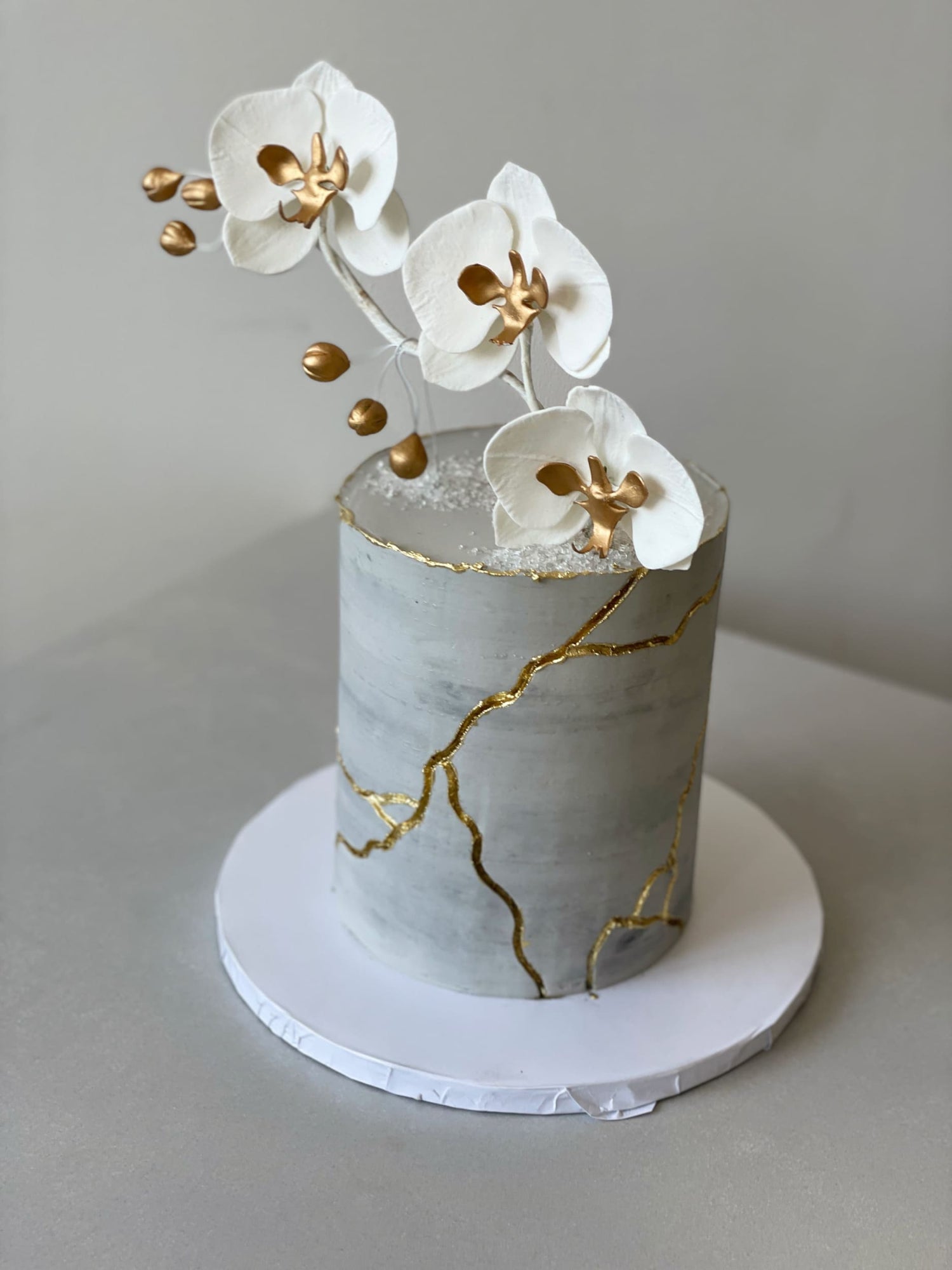 Kintsugi and fresh orchid flowers on buttercream - custom cake