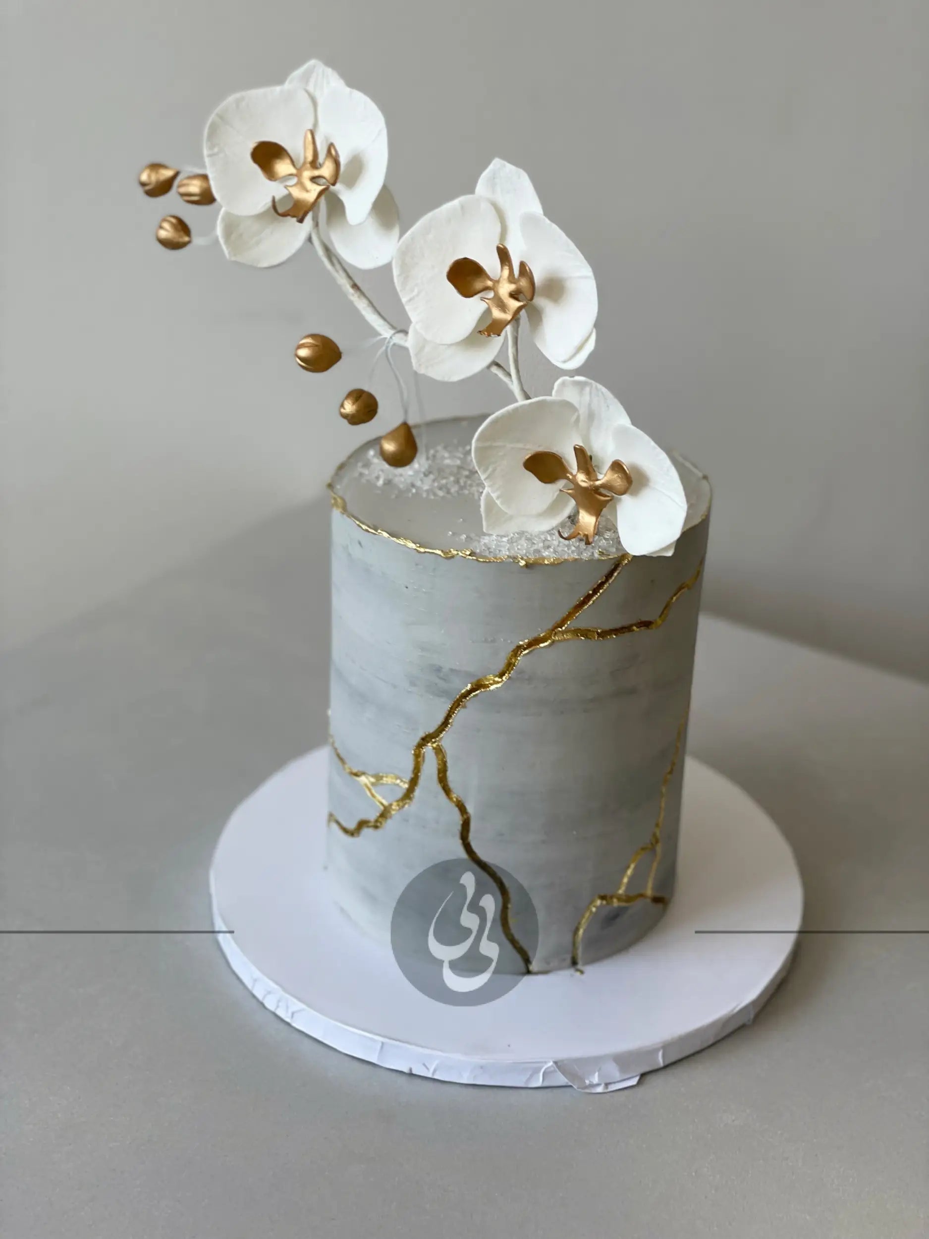 Kintsugi and fresh orchid flowers on buttercream - custom cake