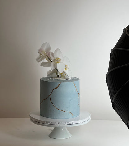Kintsugi and fresh orchid flowers on buttercream - custom cake