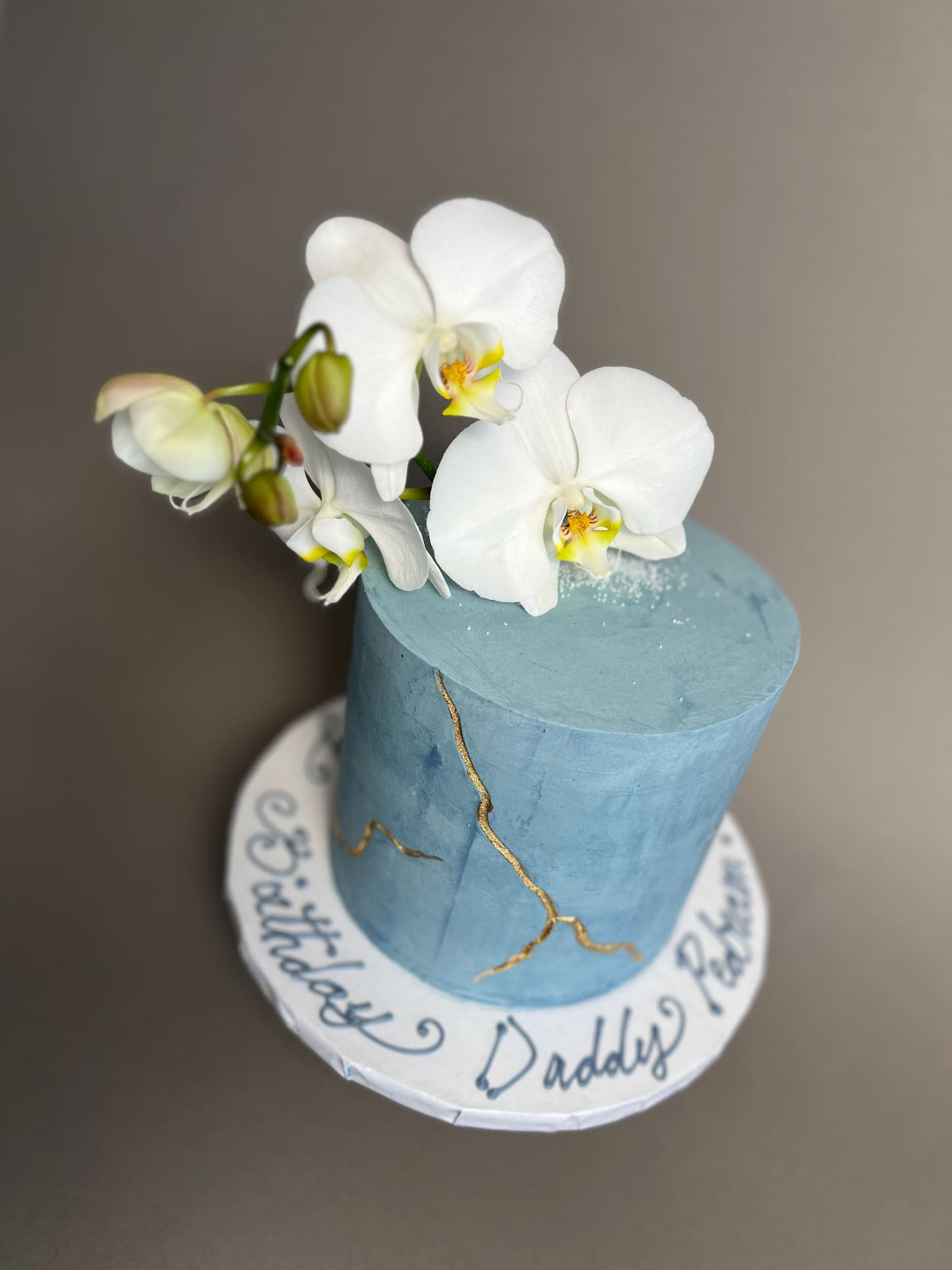 Kintsugi and fresh orchid flowers on buttercream - custom cake