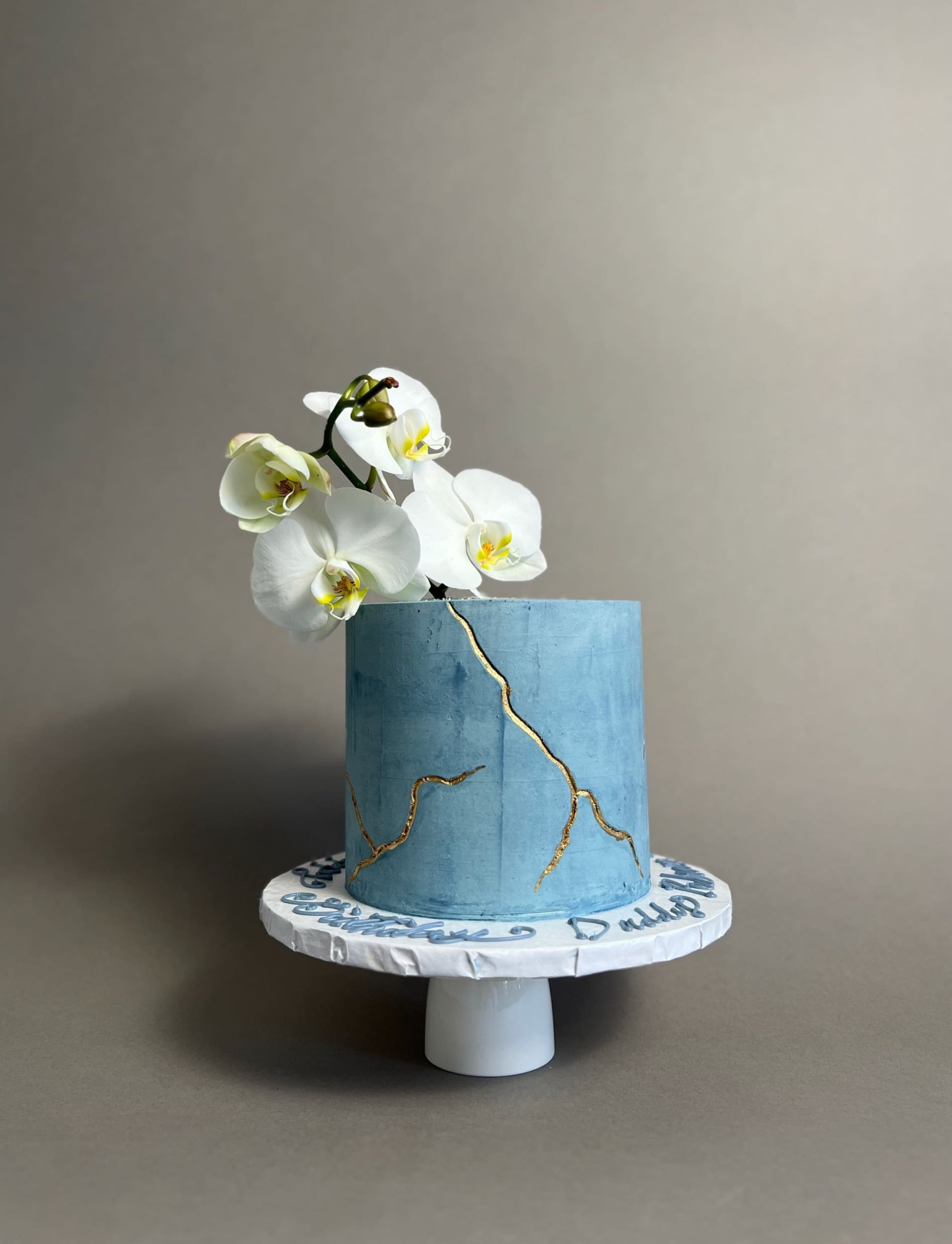 Kintsugi and fresh orchid flowers on buttercream - custom cake