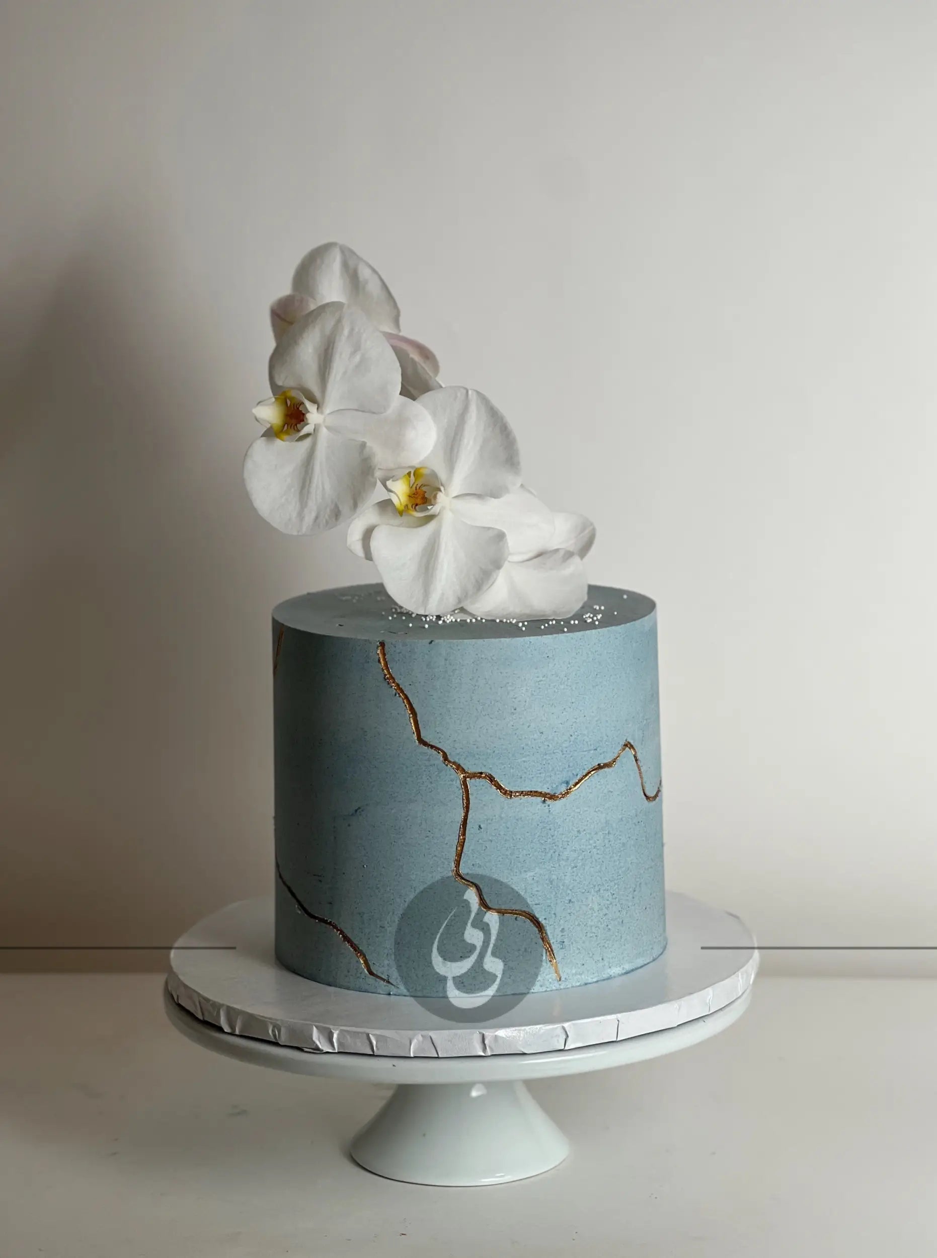 Kintsugi and fresh orchid flowers on buttercream - custom cake