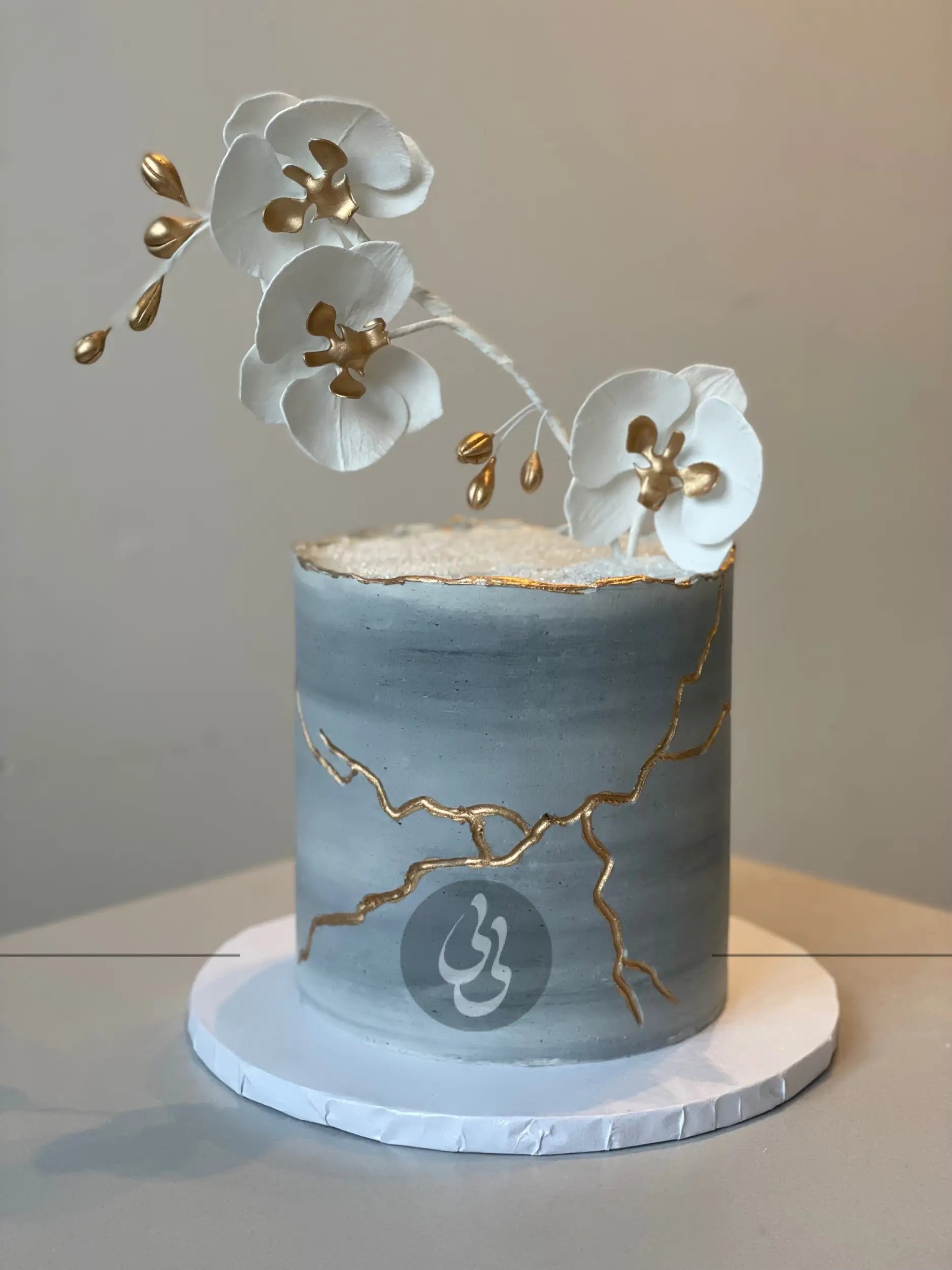 Kintsugi and fresh orchid flowers on buttercream - custom cake