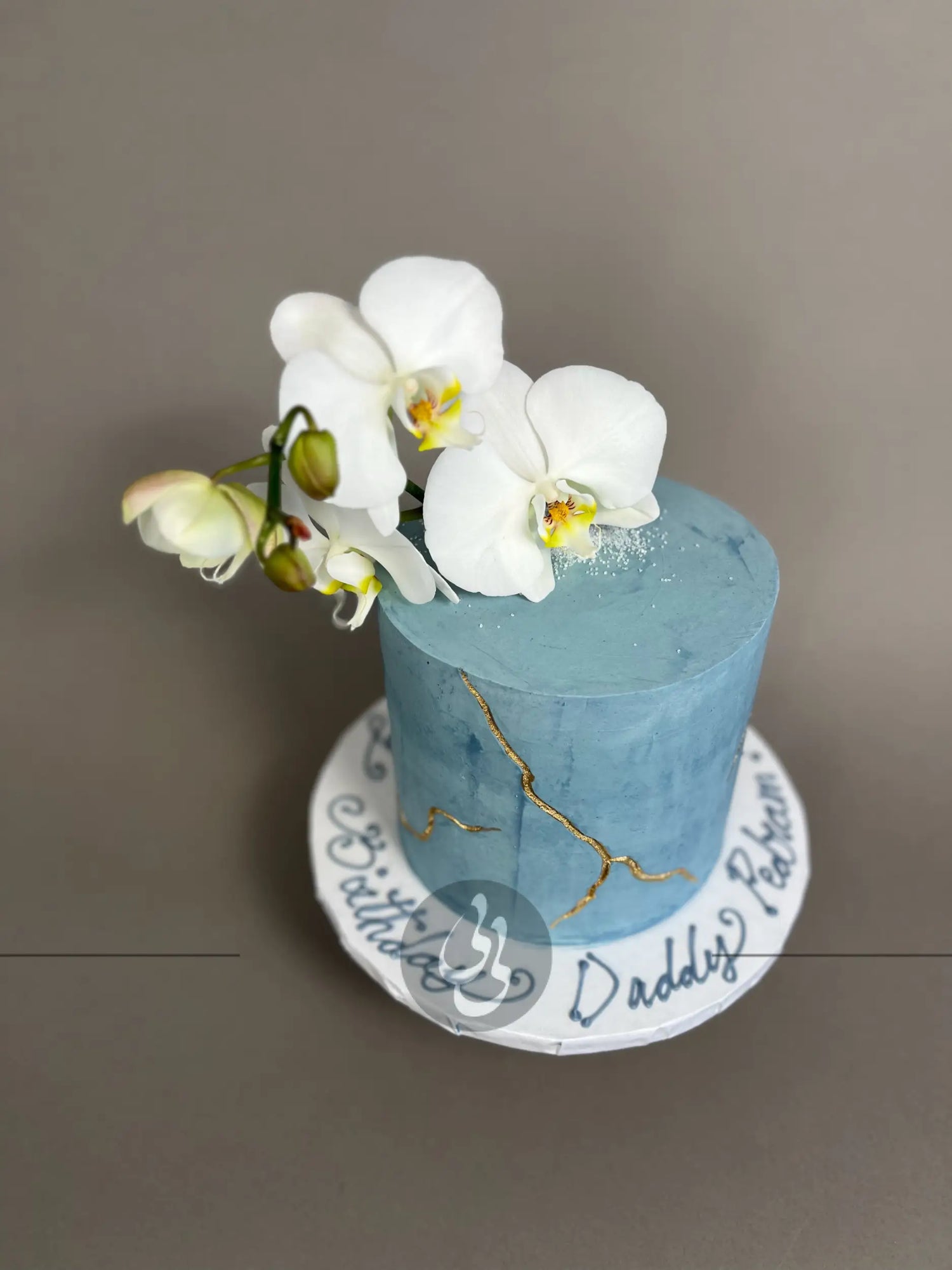 Kintsugi and fresh orchid flowers on buttercream - custom cake