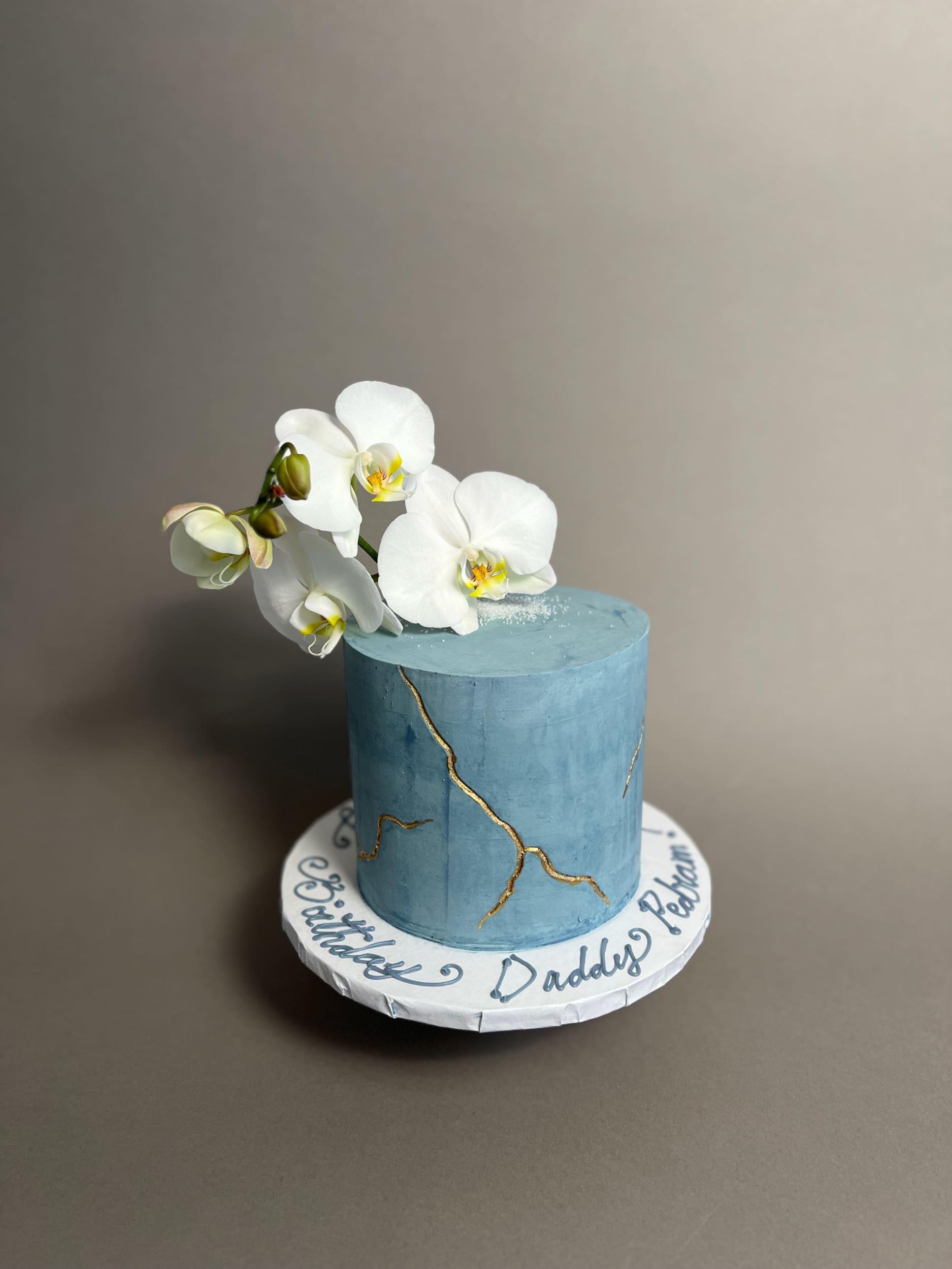 Kintsugi and fresh orchid flowers on buttercream - custom cake