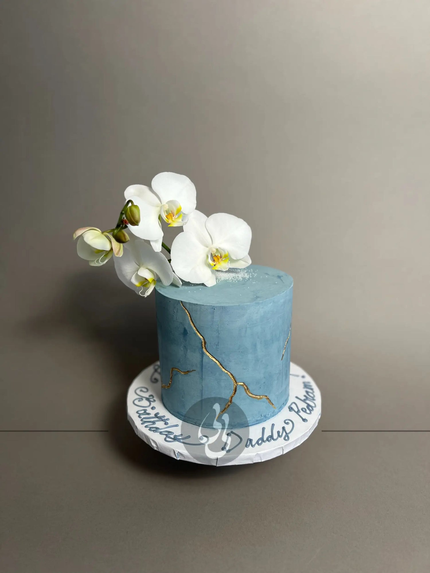 Kintsugi and fresh orchid flowers on buttercream - custom cake