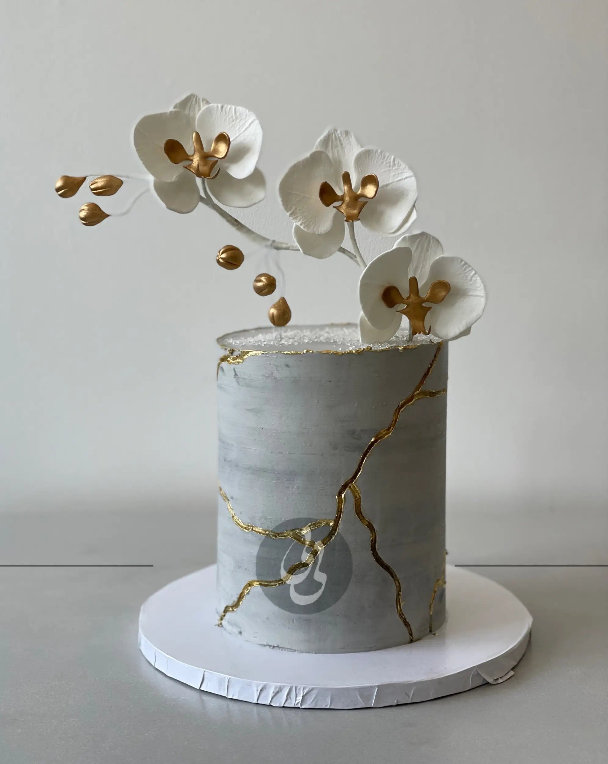 Kintsugi and fresh orchid flowers on buttercream - custom cake