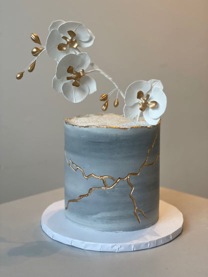 Kintsugi and sugar orchid flowers on buttercream - custom cake