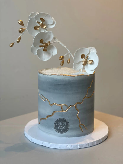 Kintsugi and sugar orchid flowers on buttercream - custom cake