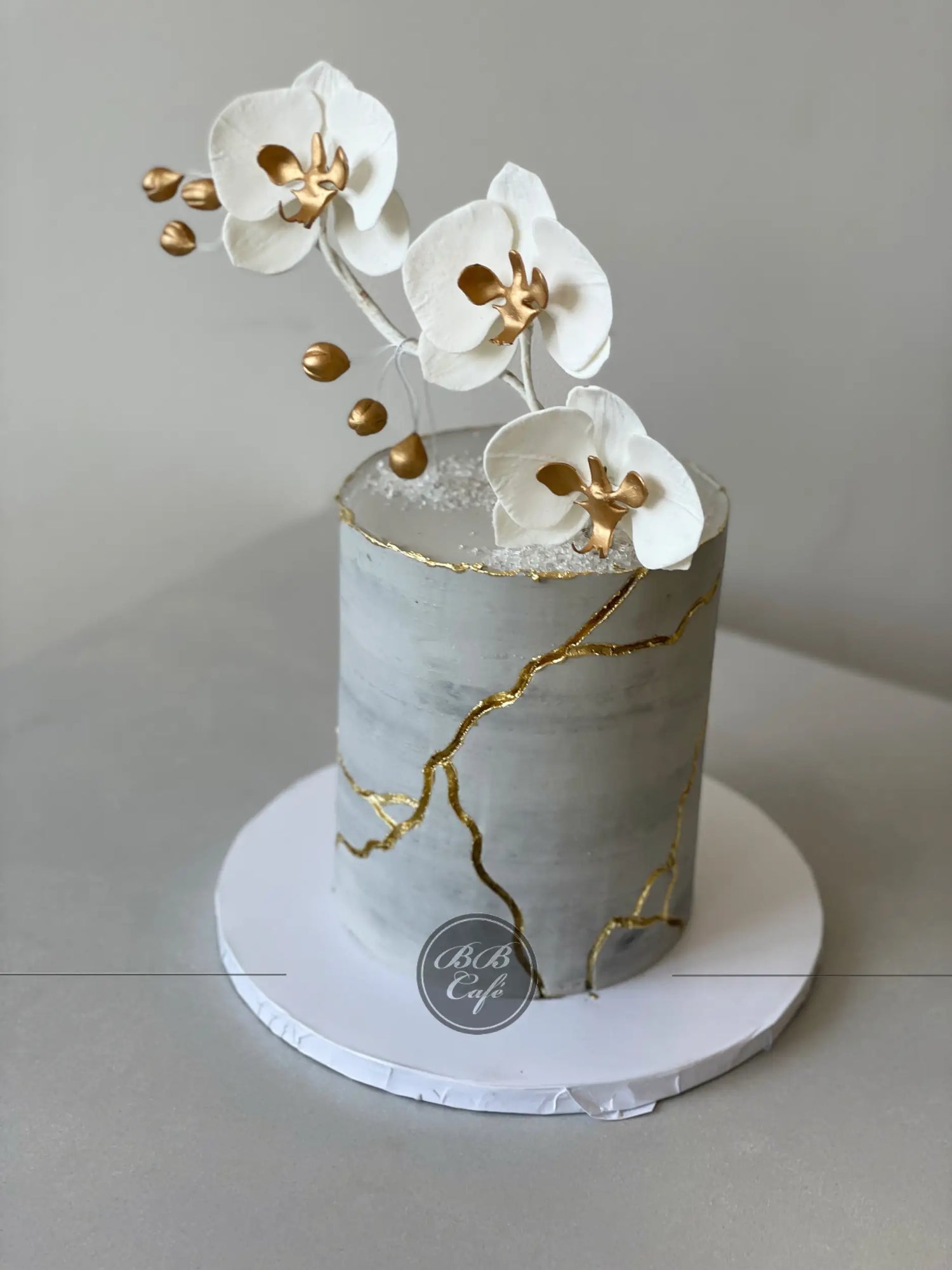 Kintsugi and sugar orchid flowers on buttercream - custom cake