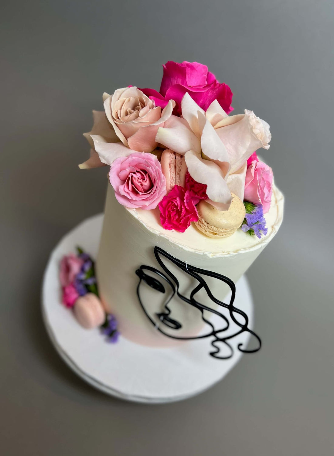 Laser-cut face &amp; floral buttercream cake - custom cake