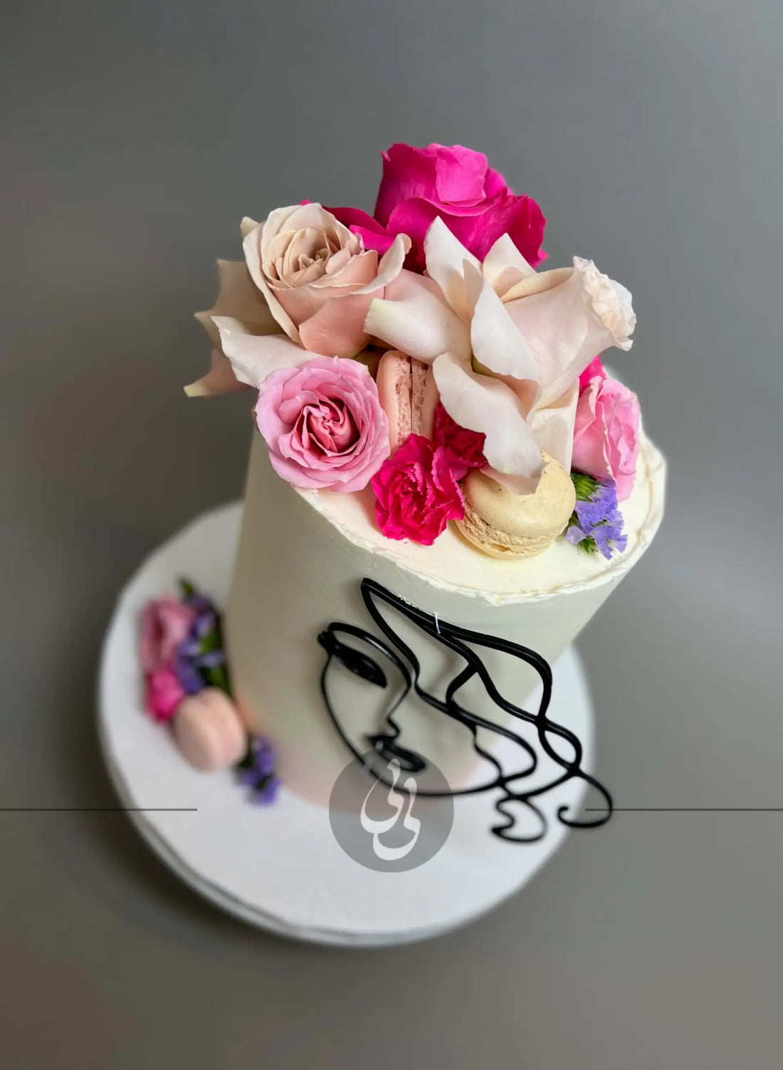 Laser-cut face &amp; floral buttercream cake - custom cake