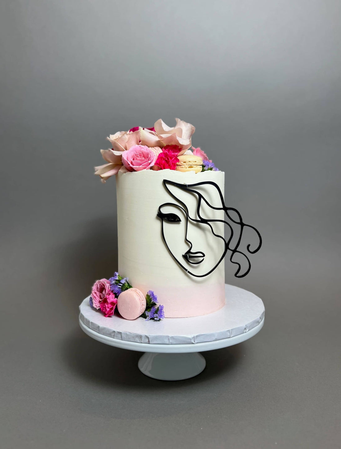 Laser-cut face & floral buttercream cake - custom cake