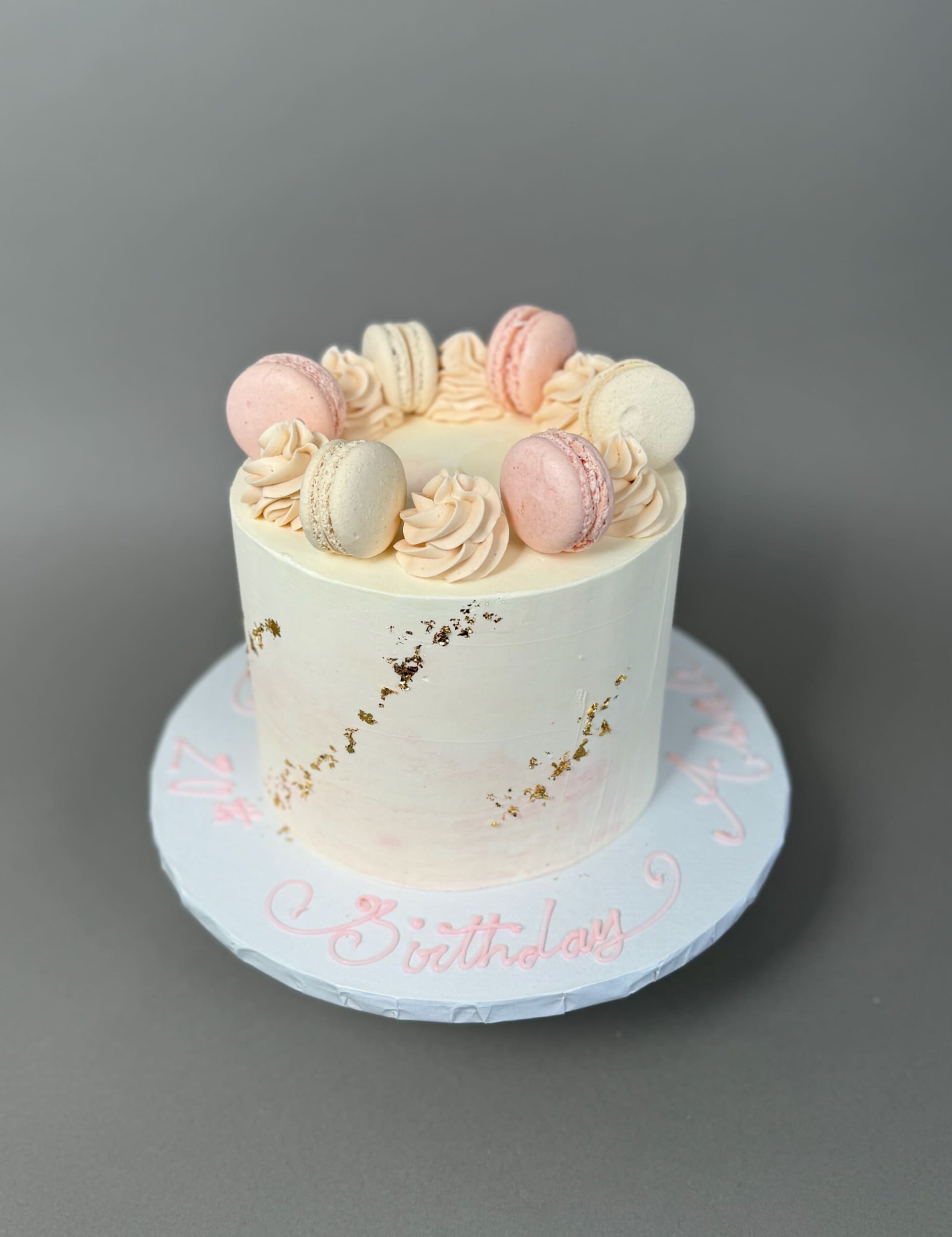 Macarons &amp; gold foil on marble buttercream - custom cake