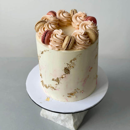 Macarons &amp; gold foil on marble buttercream - custom cake