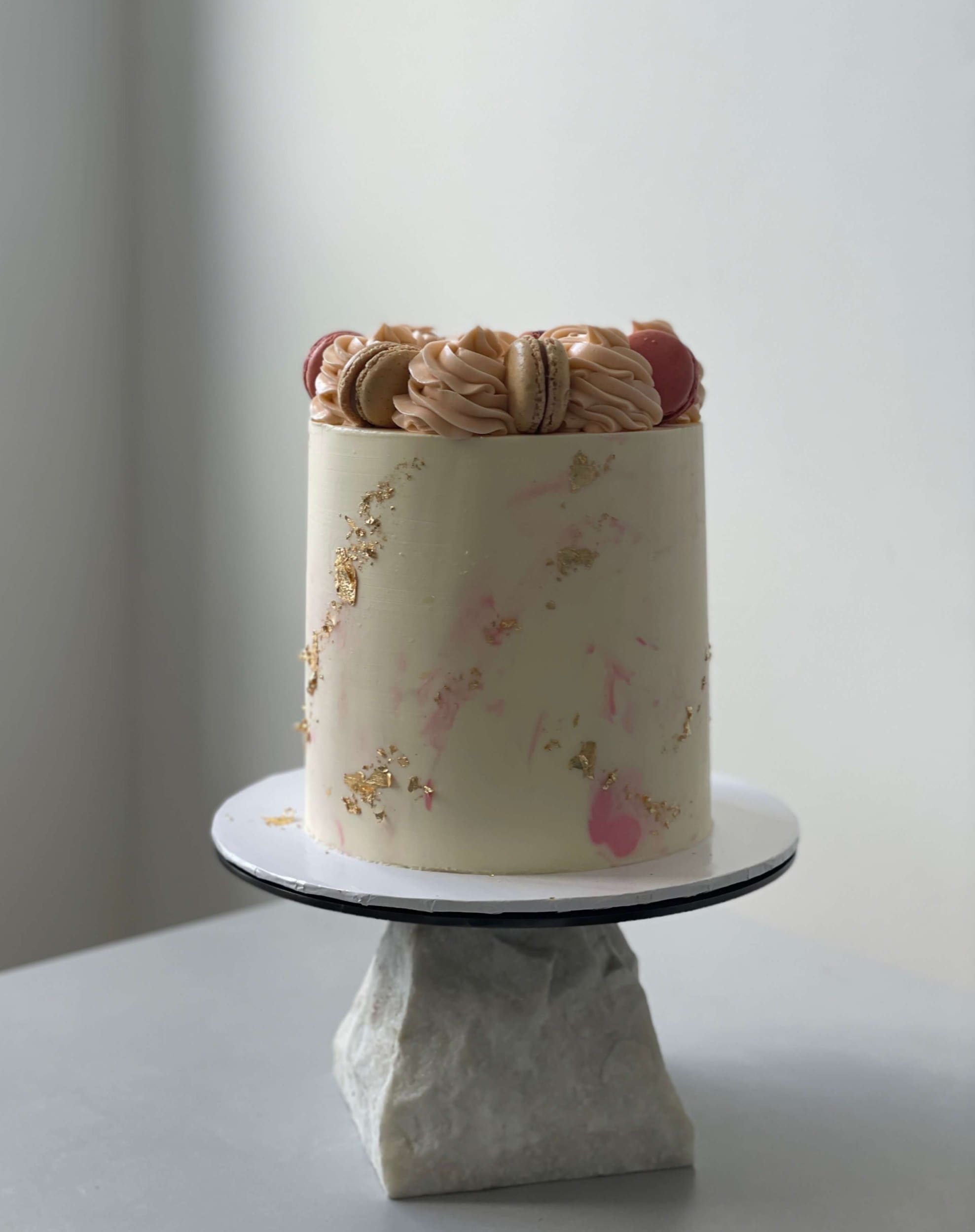 Macarons &amp; gold foil on marble buttercream - custom cake