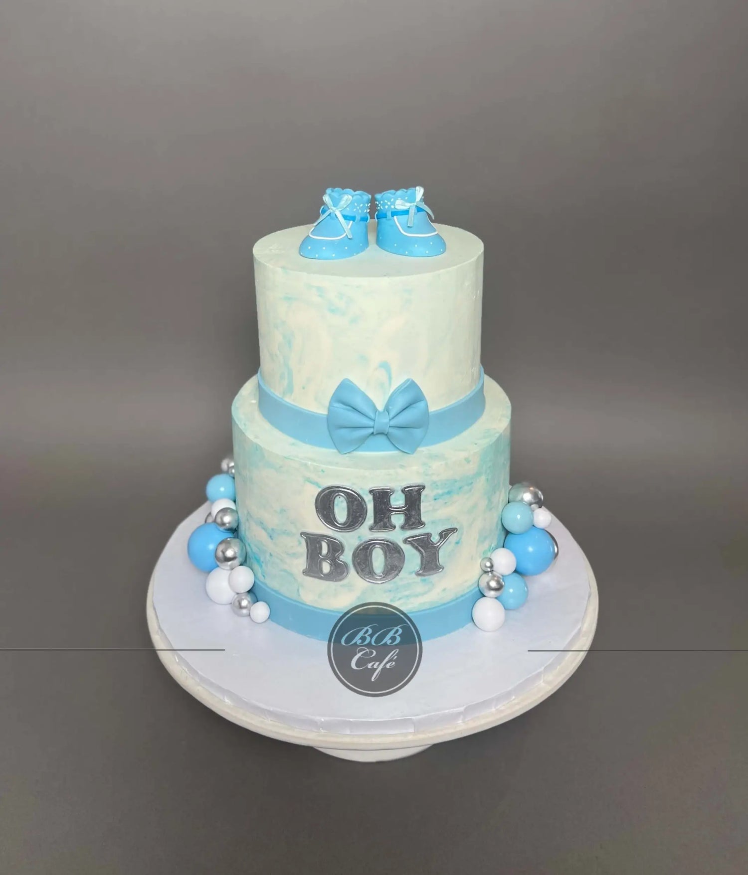 Oh baby booties on marble buttercream - custom cake