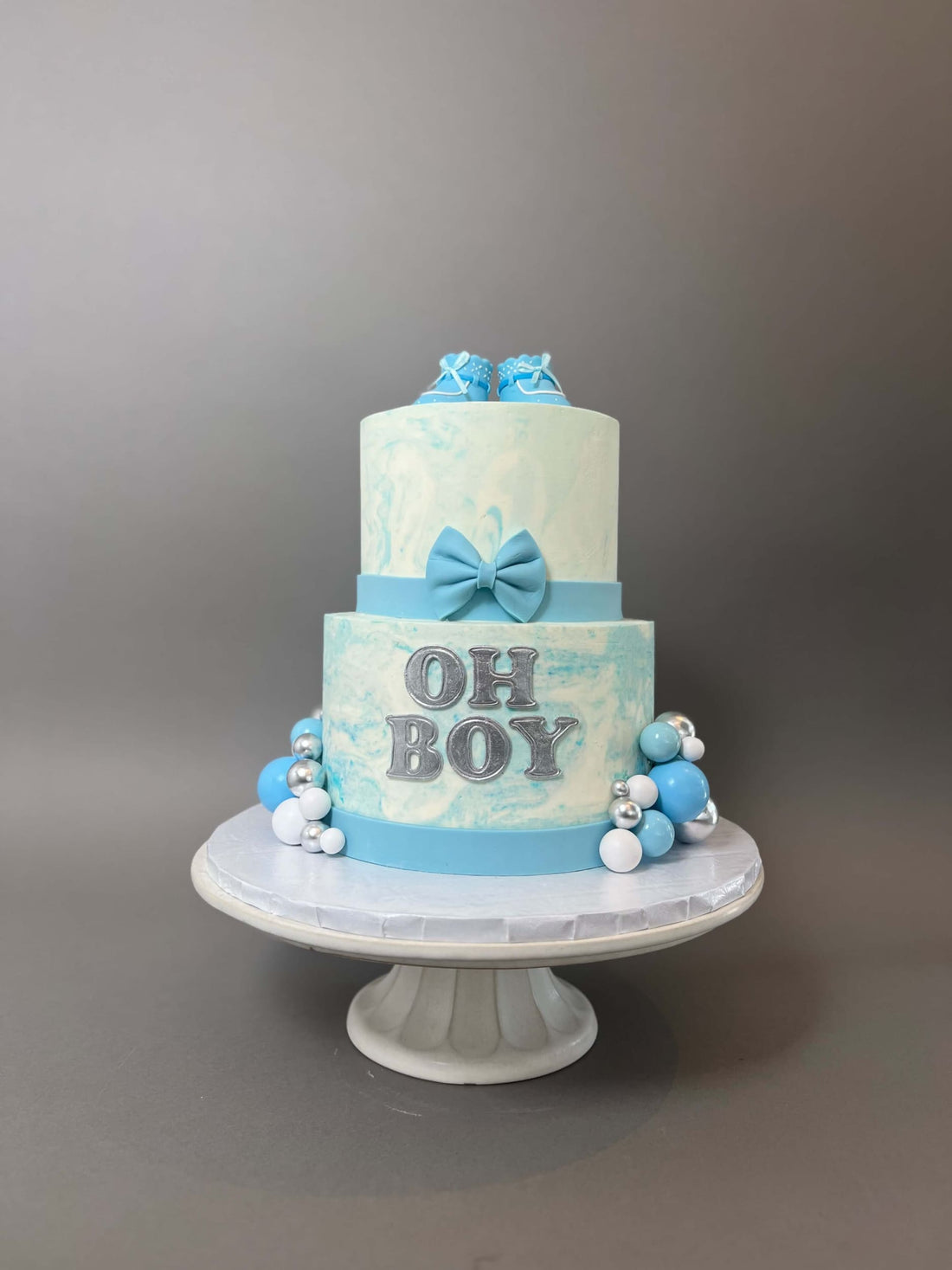 Oh baby booties on marble buttercream - custom cake