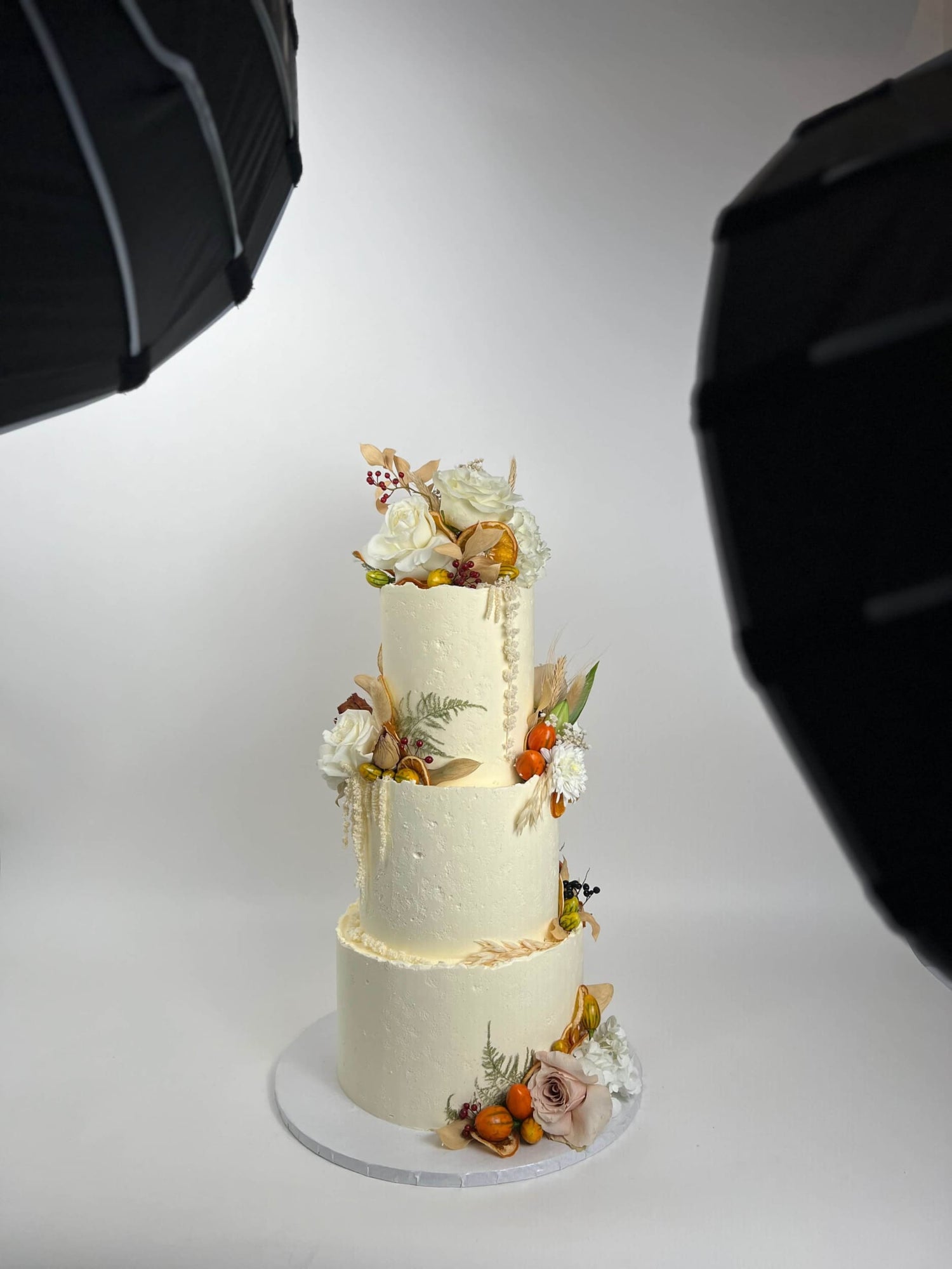Seasonal fruits &amp; fresh flowers on deckled edge buttercream - wedding cake