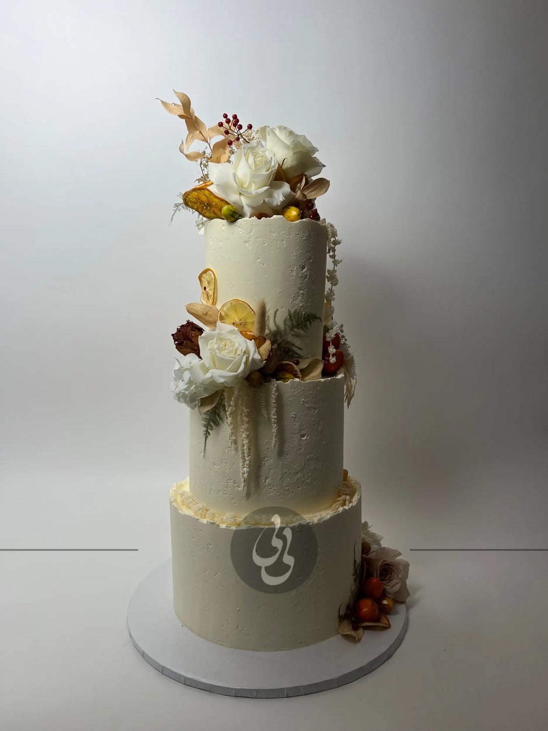 Seasonal fruits & fresh flowers on deckled edge buttercream - wedding cake