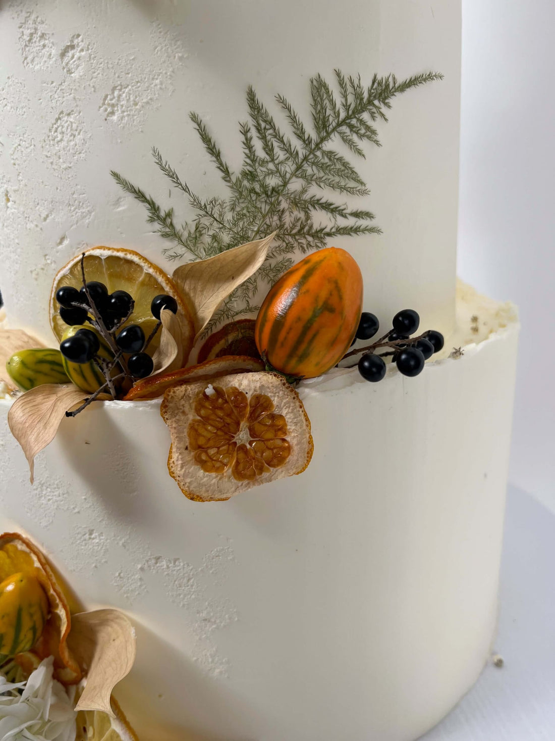 Seasonal fruits &amp; fresh flowers on deckled edge buttercream - wedding cake