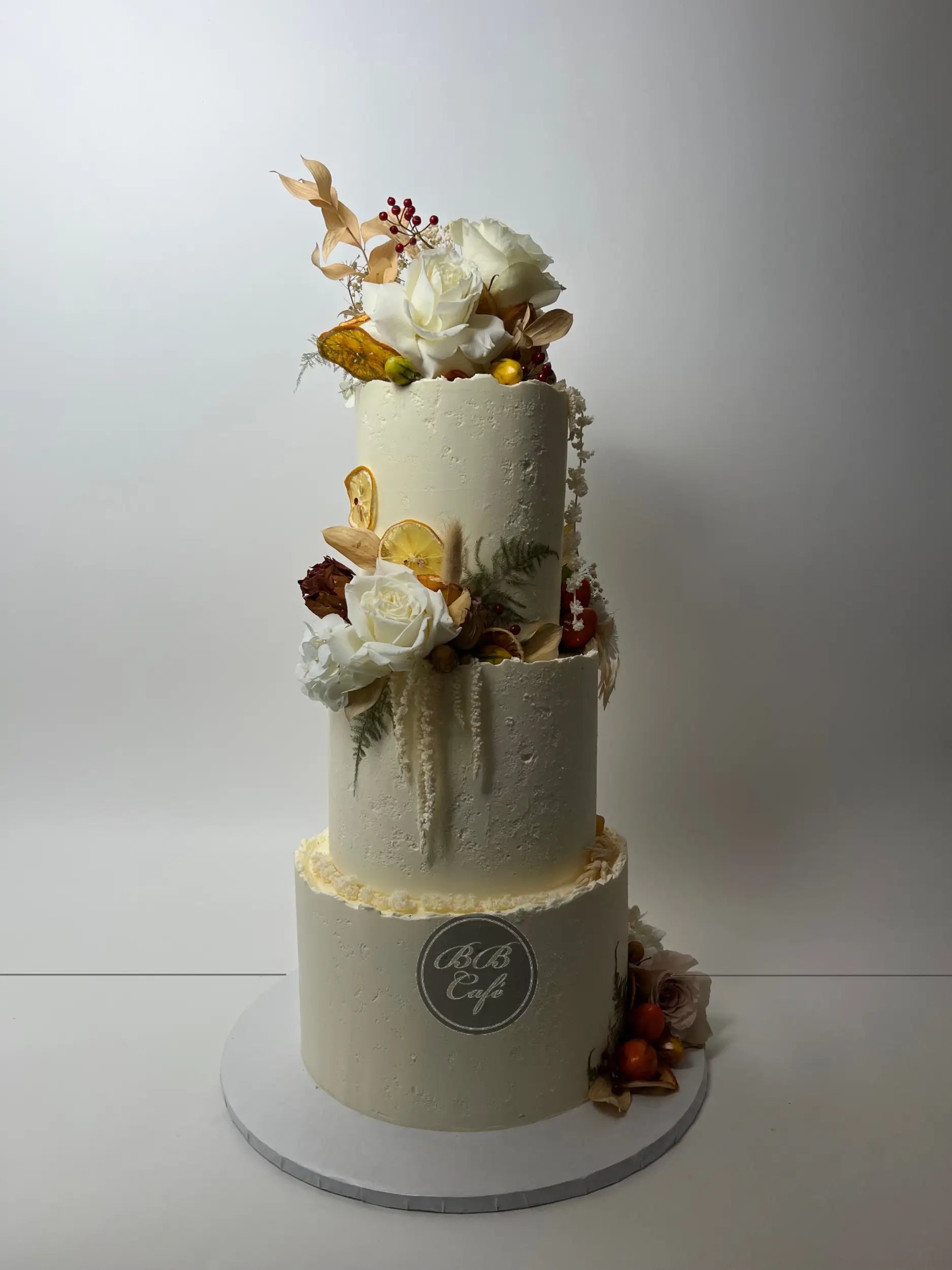 Seasonal fruits &amp; fresh flowers on deckled edge buttercream - wedding cake